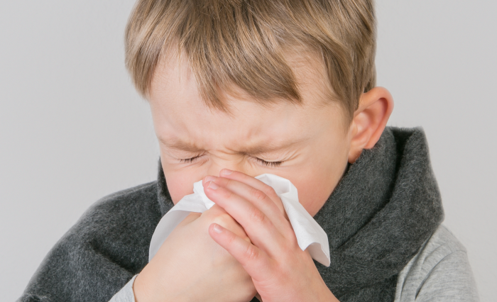 child blowing nose