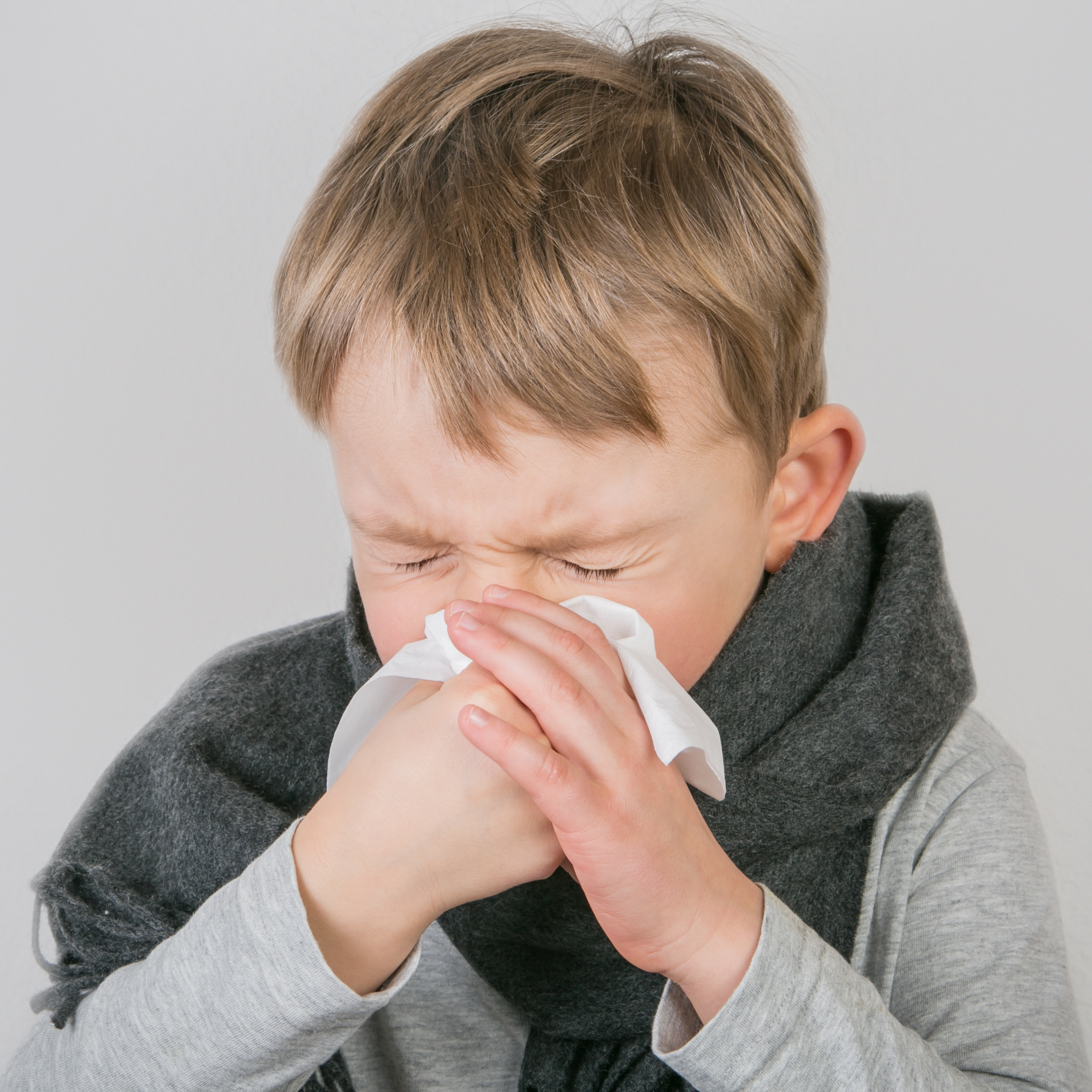 child blowing nose