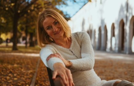 A woman sitting calmly on a park bench, reflecting the menopause transition