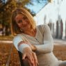 A woman sitting calmly on a park bench, reflecting the menopause transition